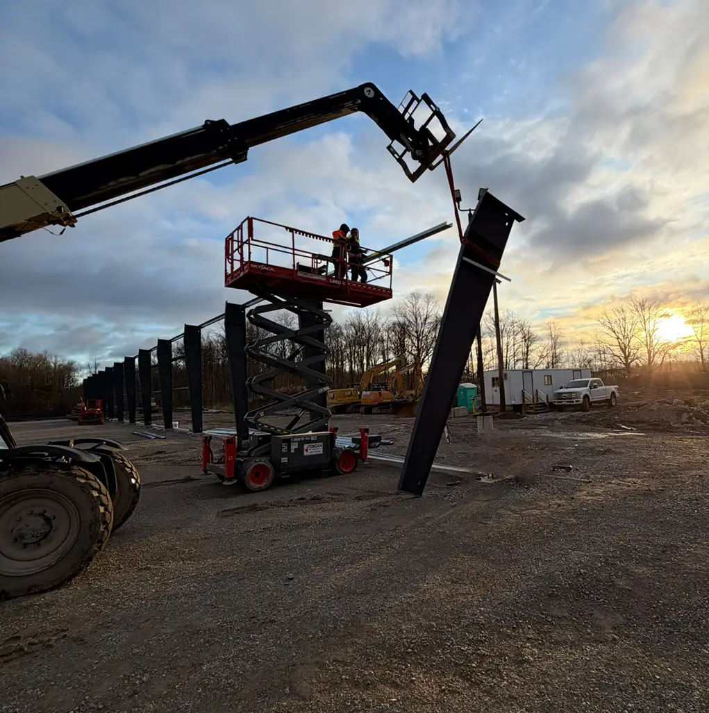 Steel building frame erection during construction showing on-site installation of prefabricated structural steel